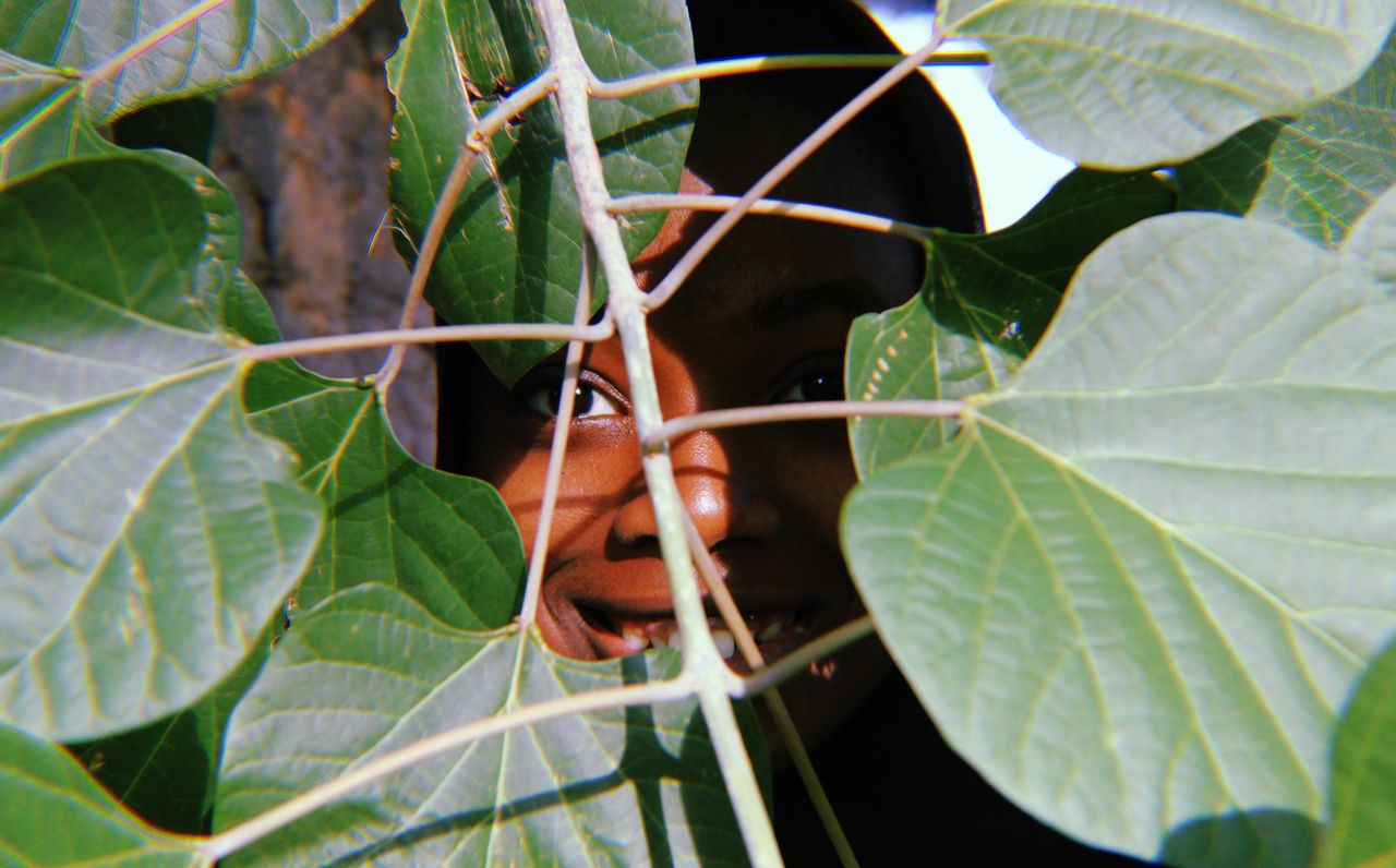 A person smiling warmly with smile lines around the eyes
