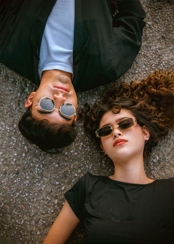A pair of sunglasses resting on a bright sunlit surface